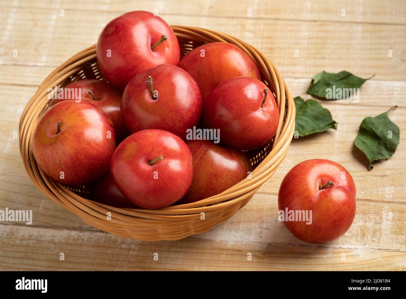 Basket with fresh sweet ripe cherry plums close up Stock Photo
