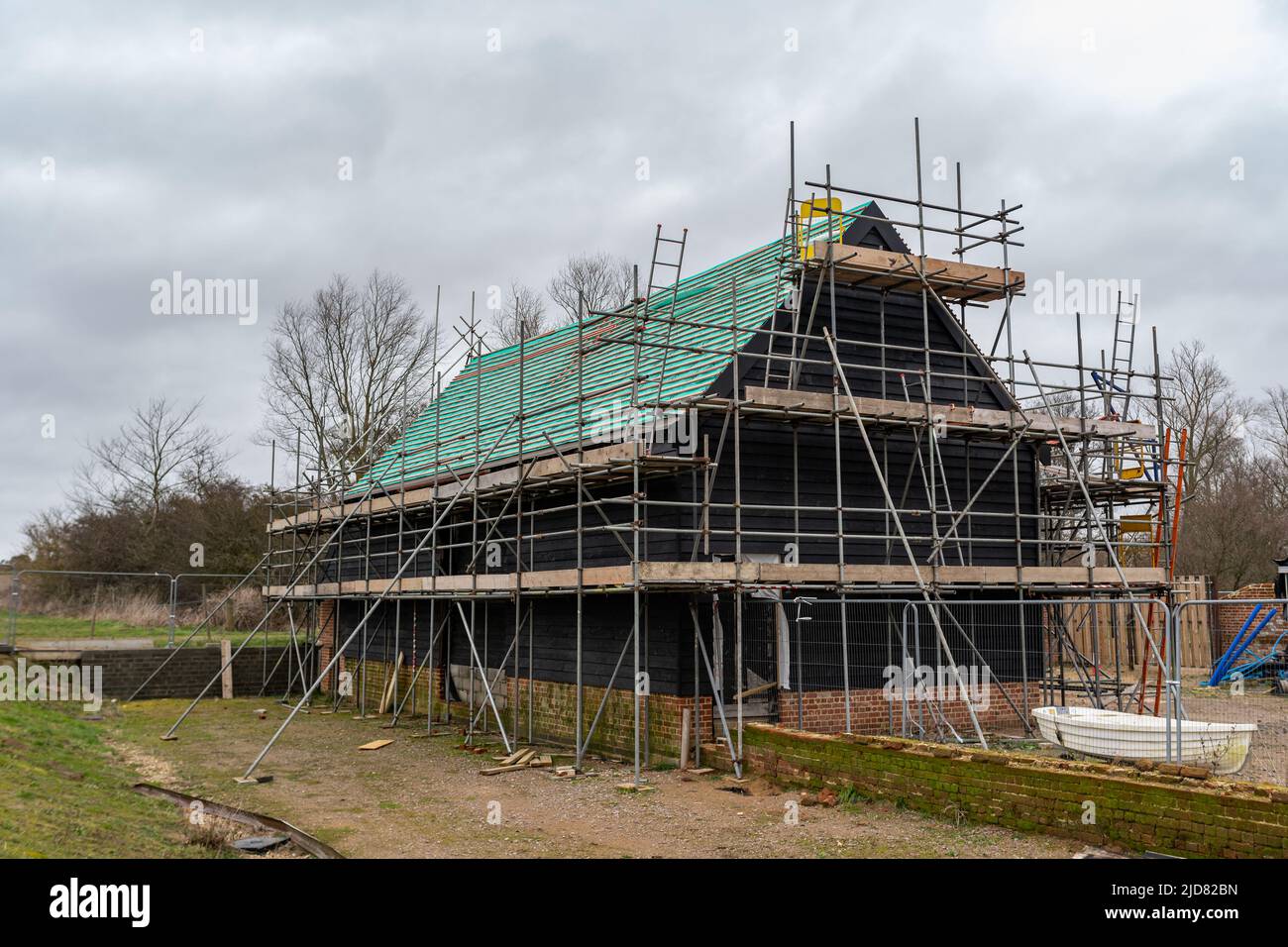 Woodbridge Suffolk UK February 20 2022: An old barn and stables that are in the middle of getting converted into a modern family home Stock Photo