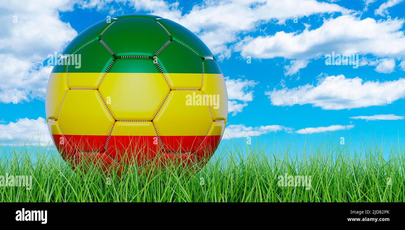 Ball Rasta Colors Soccer ball with Rastafarian flag on the green grass against blue sky ...