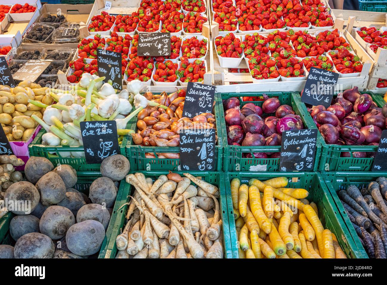 Vegetables and strawberries for sale at a market Stock Photo