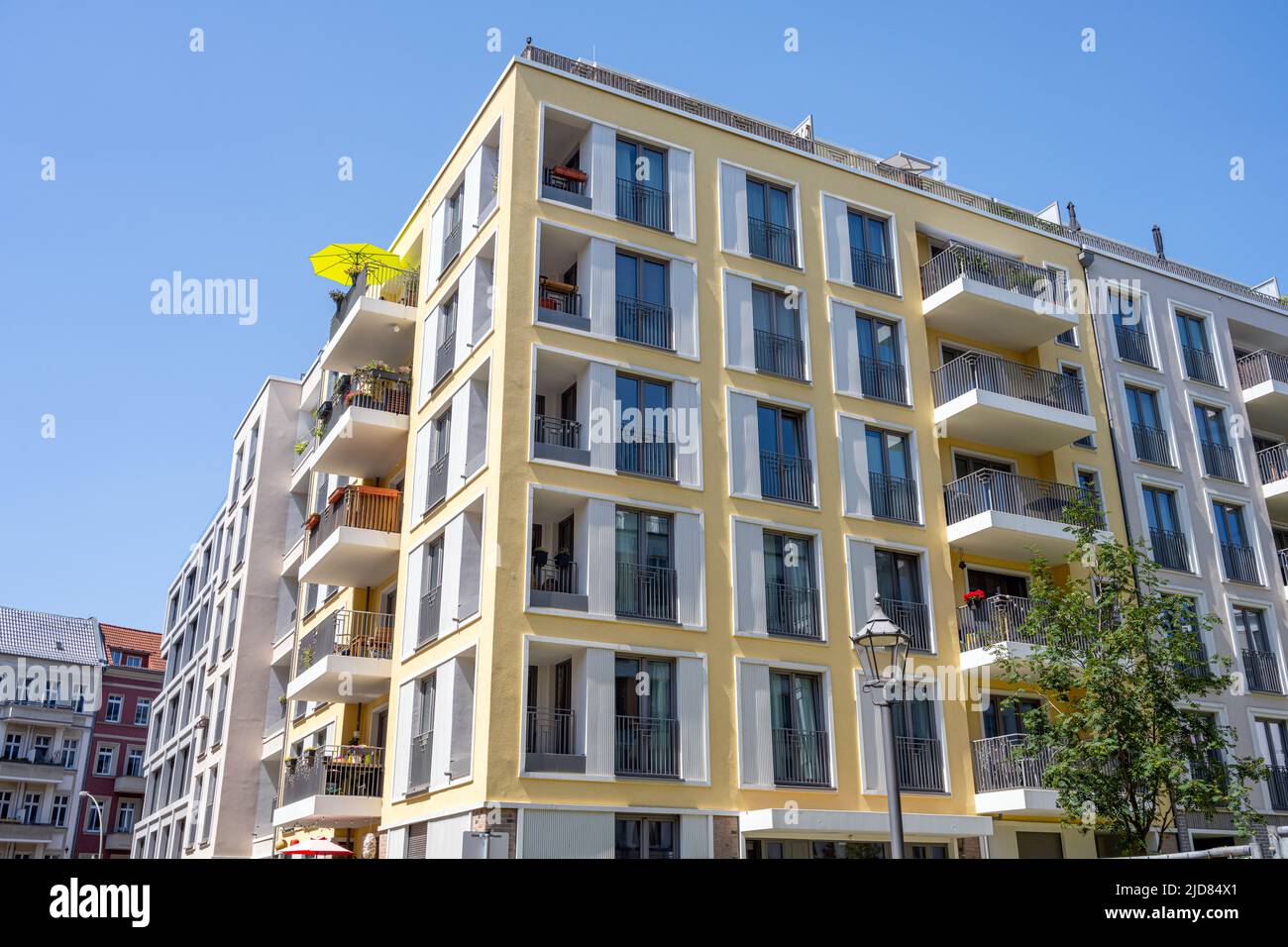 Modern apartment house with a yellow parasol seen in Berlin Stock Photo