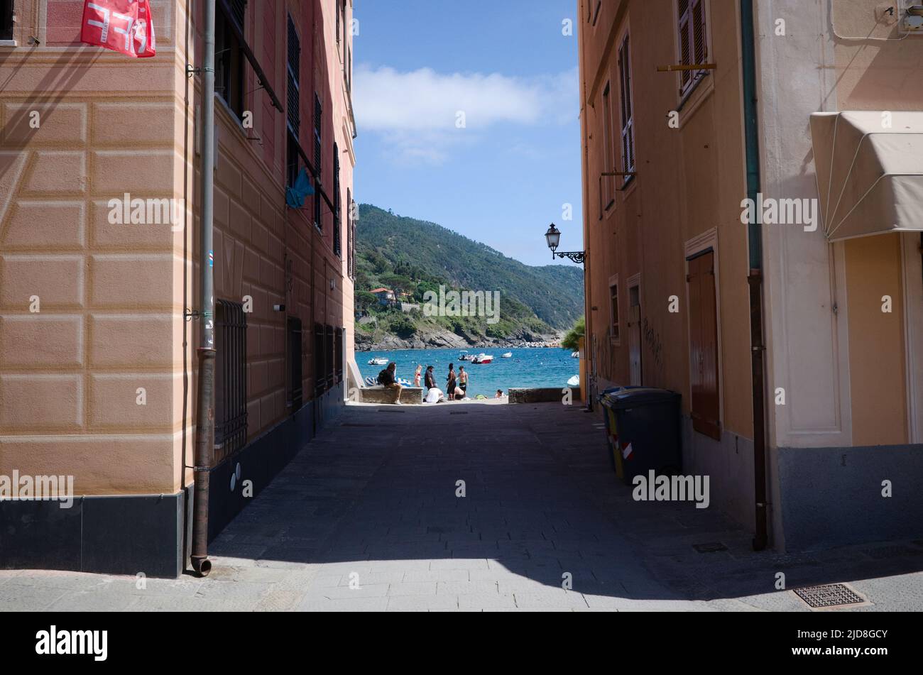 Sestri Levante, Liguria, Italy - April, 2022: Access to sea, beach and Baia del Silenzio bay through narrow passage between two residential buildings Stock Photo