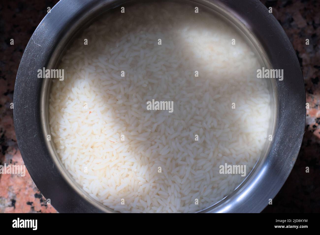 Rice soaked in water before cooking, rice preparation recipe Stock Photo Alamy