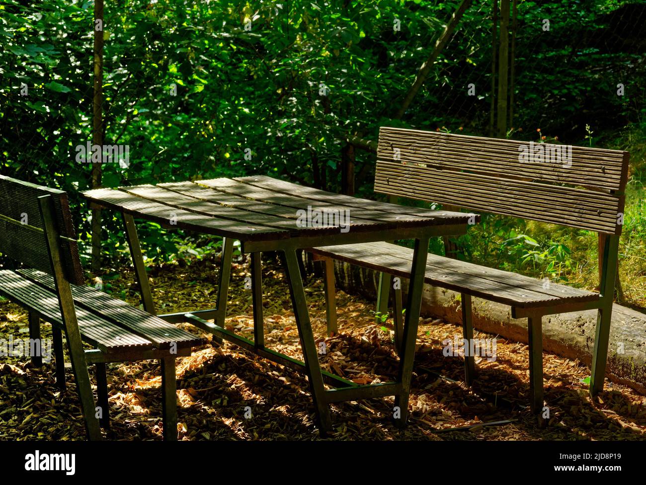 a beautiful resting place with wooden bench and table outdoors Stock Photo