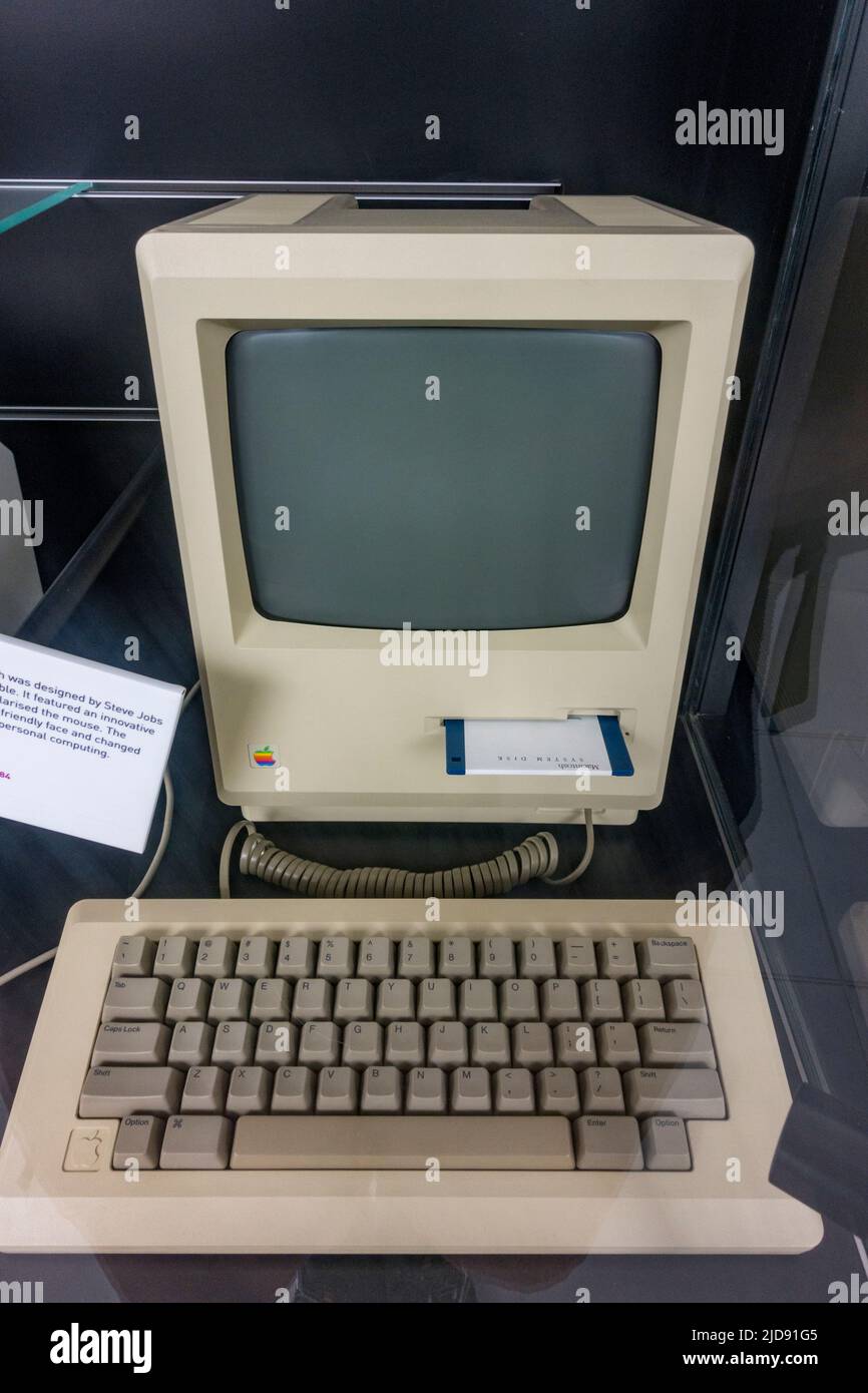 An original Apple Macintosh (1984) computer designed by Steve Jobs which introduced the mouse graphical interface on display in a media museum. Stock Photo