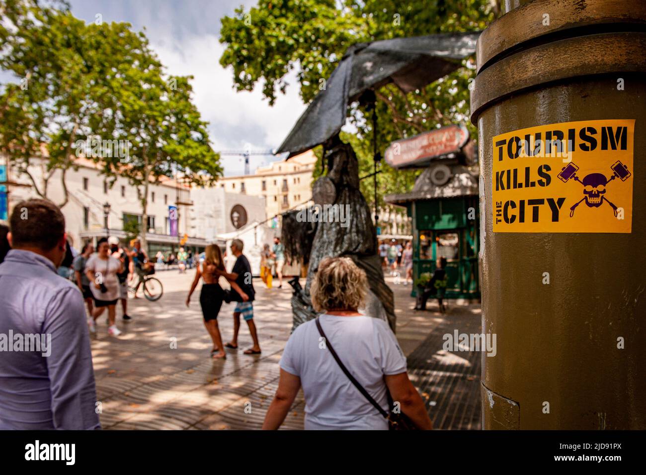 A sticker placed in la Rambla of Barcelona reads Tourism Kills The City. Stock Photo