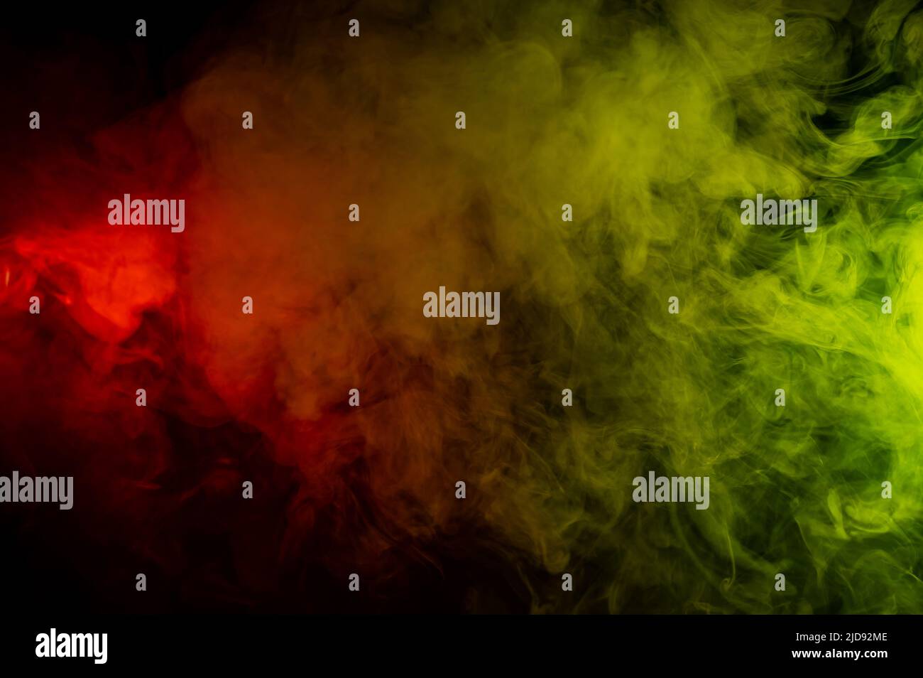 Red-yellow smoke spreads on a black background Stock Photo - Alamy