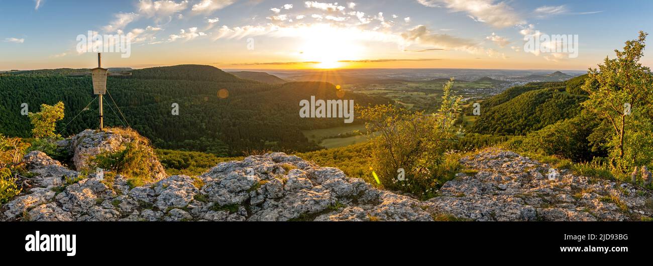 High-res panorama shot of scenic rock ledge and summit cross at sunset in the Swabian Jura in Southern Germany Stock Photo