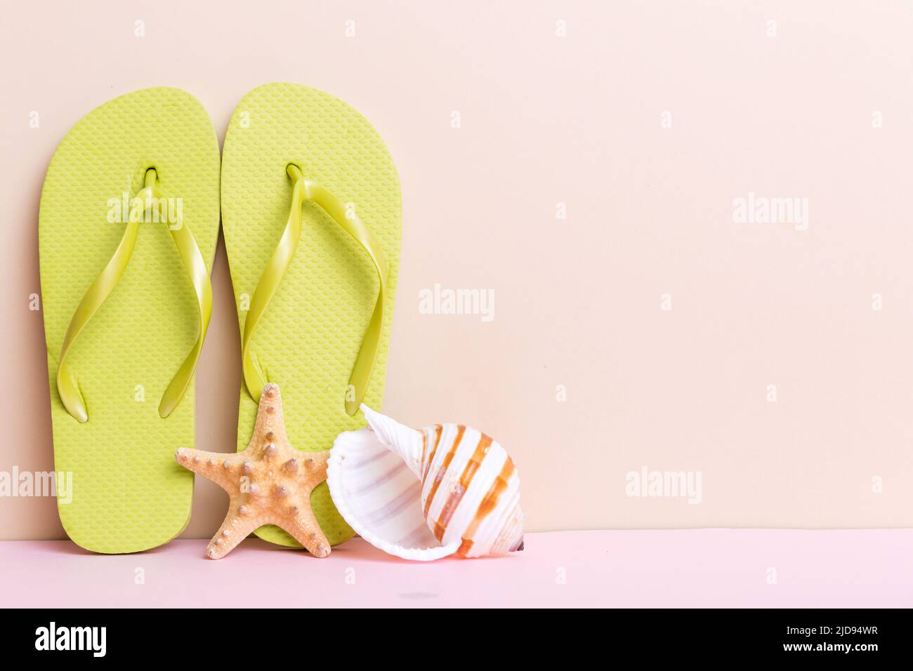 Beach accessories. Flip flops and starfish on colored background. Mock ...