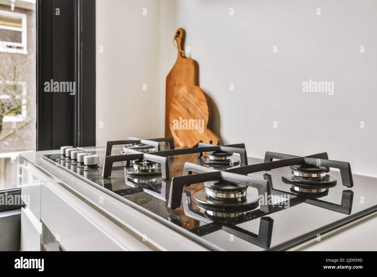 Gas stove in the kitchen. Modern kitchen at home with kitchenware Stock