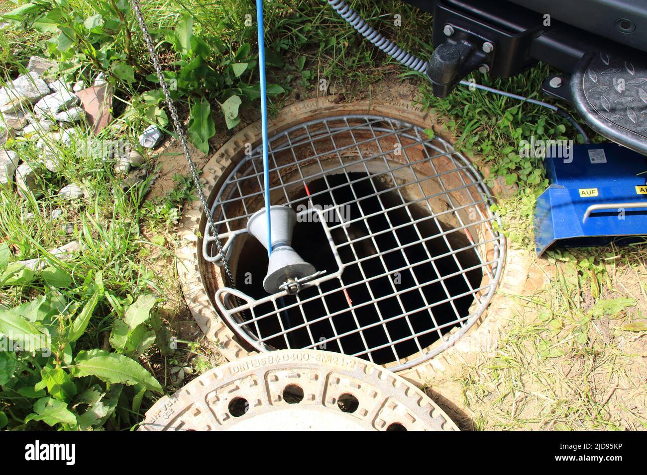 Control of a sewage shaft with camera and fall protection at the shaft Stock Photo