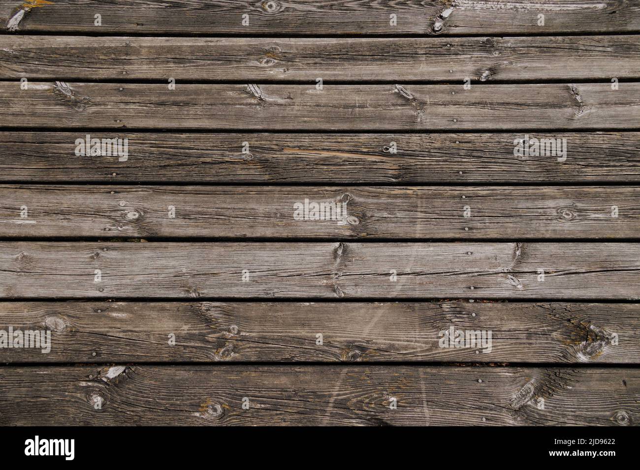 Old wooden planks of a pier in horizontal orientation Stock Photo