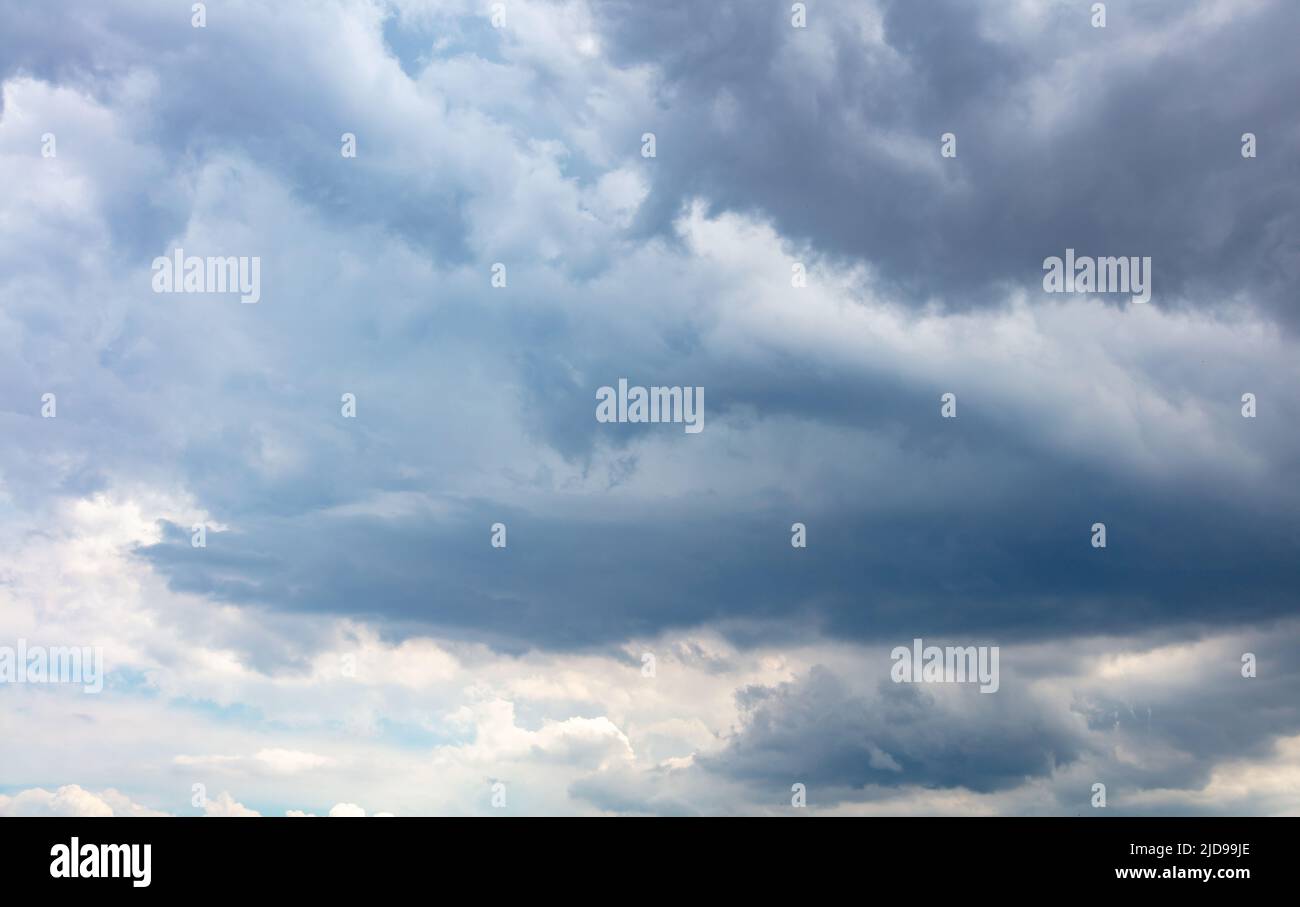 Rain cloud on blue sky background. Fluffy cumulus cloudscape white and grey shade color. Weather, meteorology concept Stock Photo
