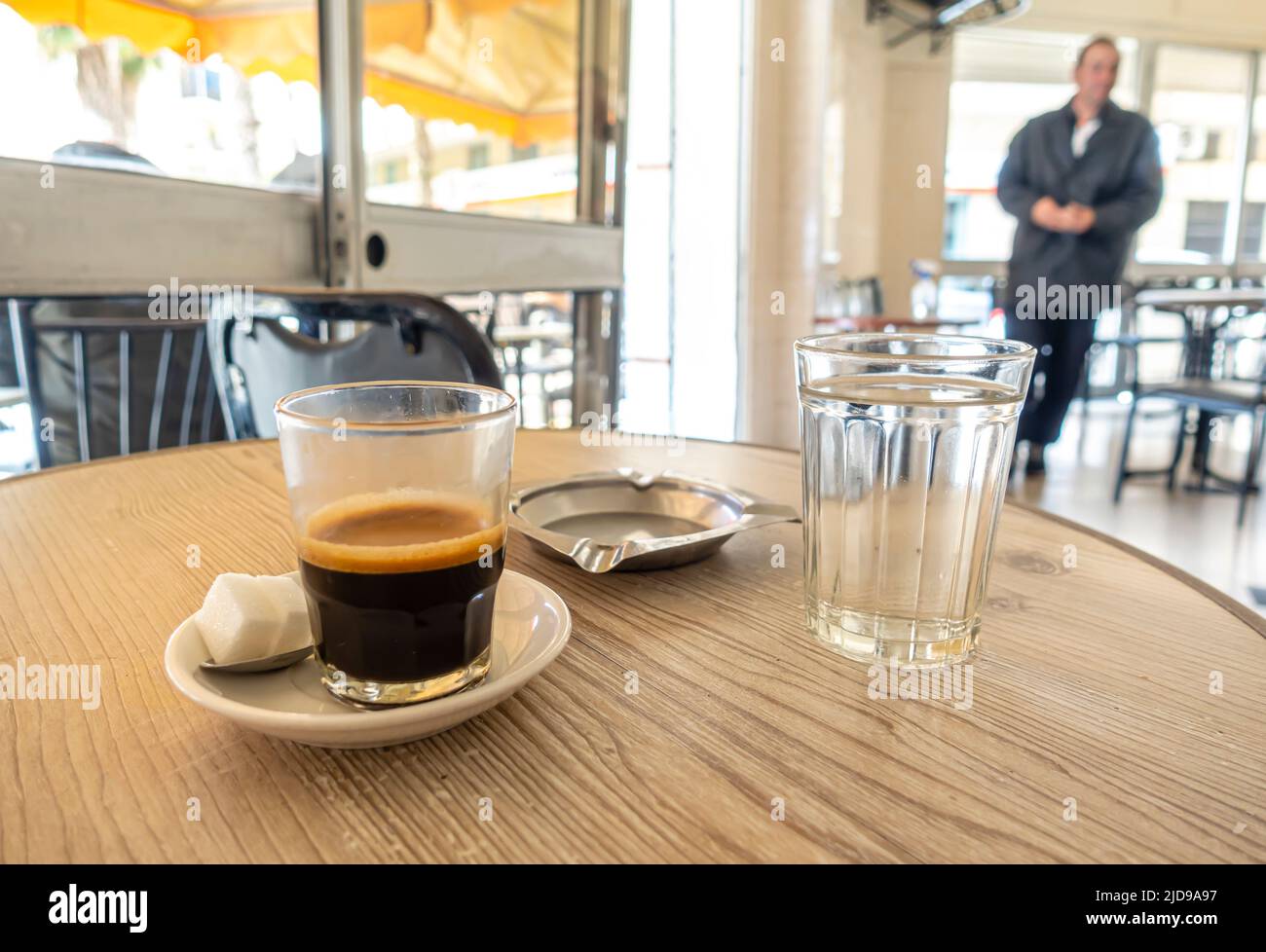 Espresso served traditionally in glass, sugar, water in cafe in Casablanca, Morocco Stock Photo