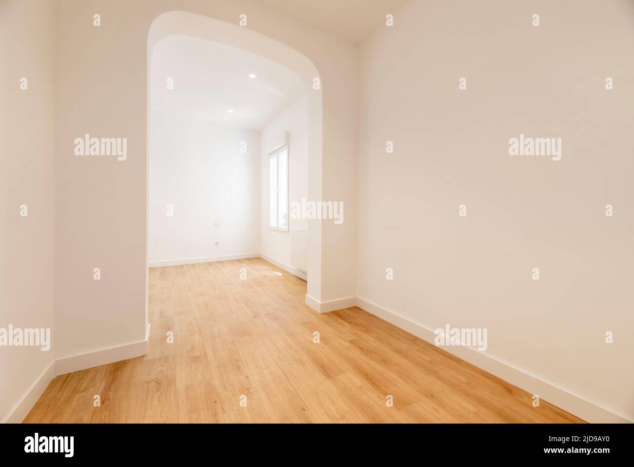 Empty living room with basket arch separating two rooms Stock Photo