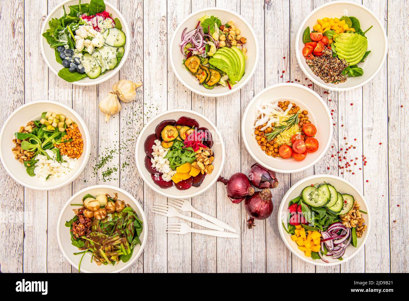 Set of white bowls full of vegetarian salads of all kinds, fresh, energizing and healthy Stock Photo