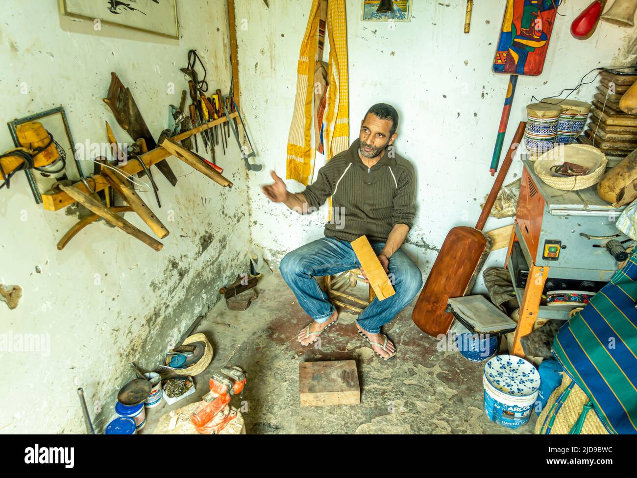 A musical instrument master in his workshop. Craftsmen in Marrakech, Morocco, North Africa Stock Photo