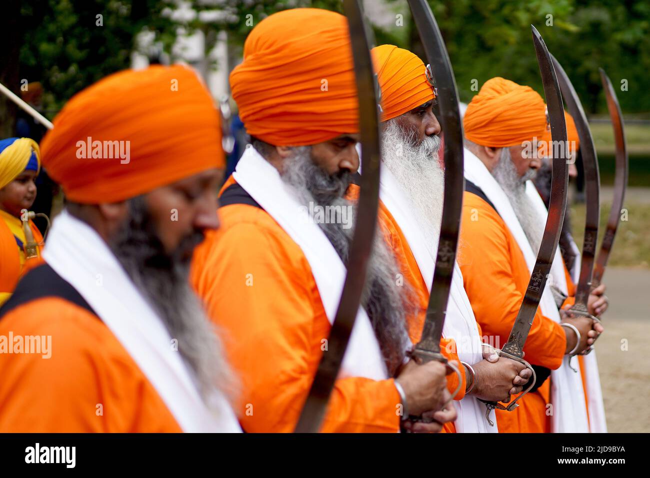 Sikh men hold their swords as they march to Trafalgar Square, London, to take part in a rally marking the 38th anniversary of the 1984 Amritsar massacre. Picture date: Sunday June 19, 2022. Stock Photo