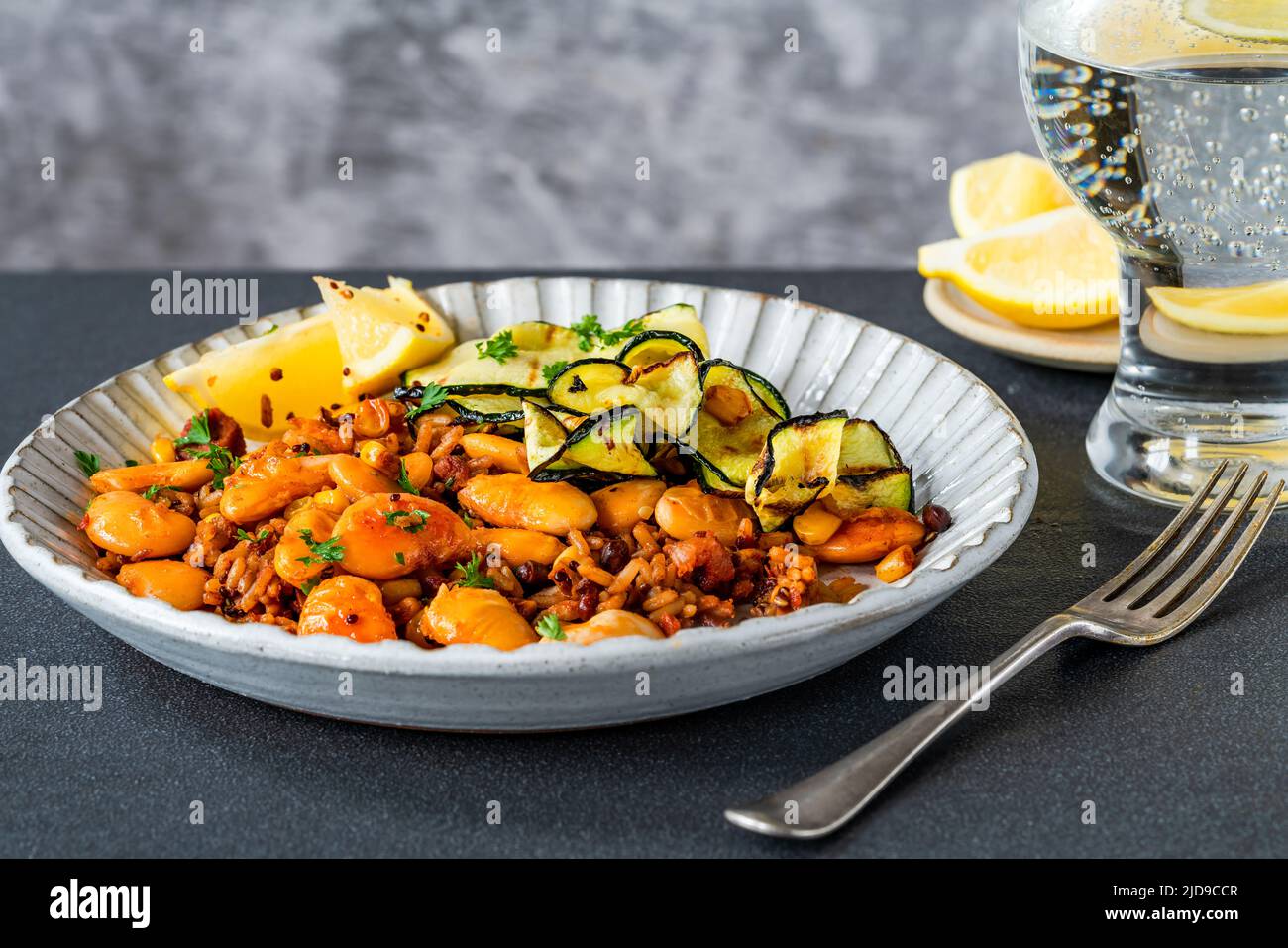 Smoky vegan grains with courgette and butter beans Stock Photo