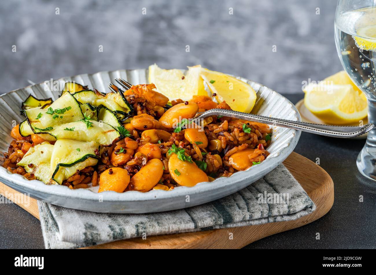 Smoky vegan grains with courgette and butter beans Stock Photo