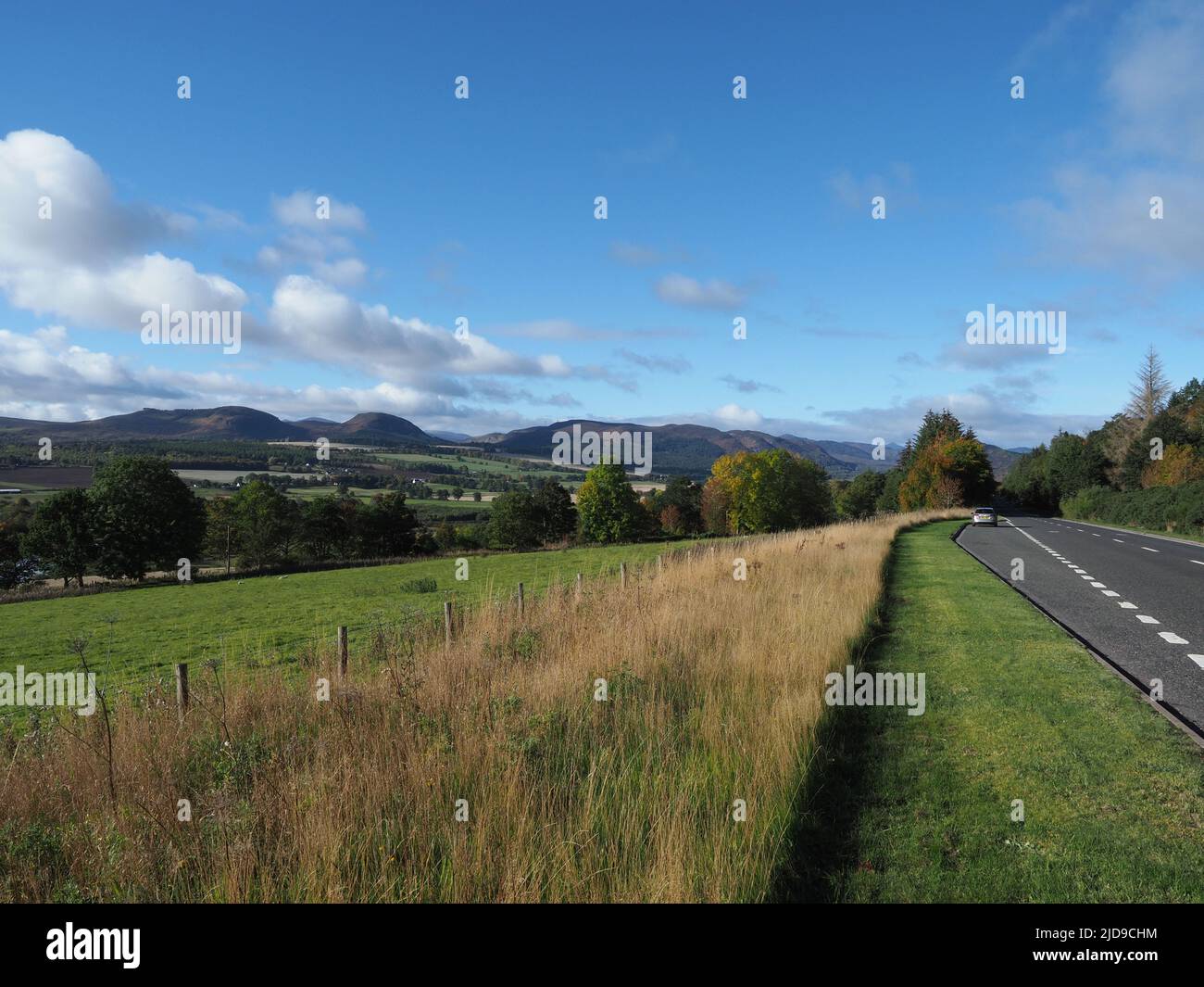 View from the A835 road near Strathpeffer. Looking over farmers fields, River Conon, with Glen Orrin and the Strathconon hills in the distance. Stock Photo