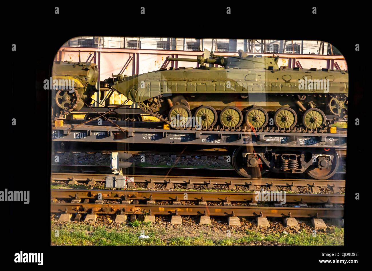 Russian tanks T 90 transported on a railroad, seen through the train window. Russia Stock Photo