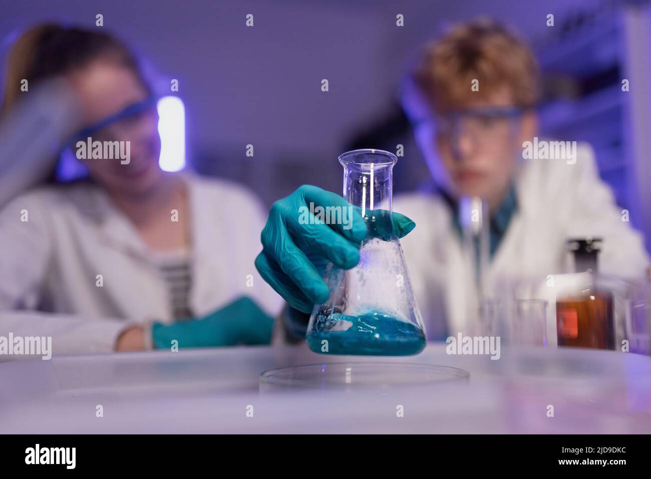 Science students doing chemical experiment in the laboratory at