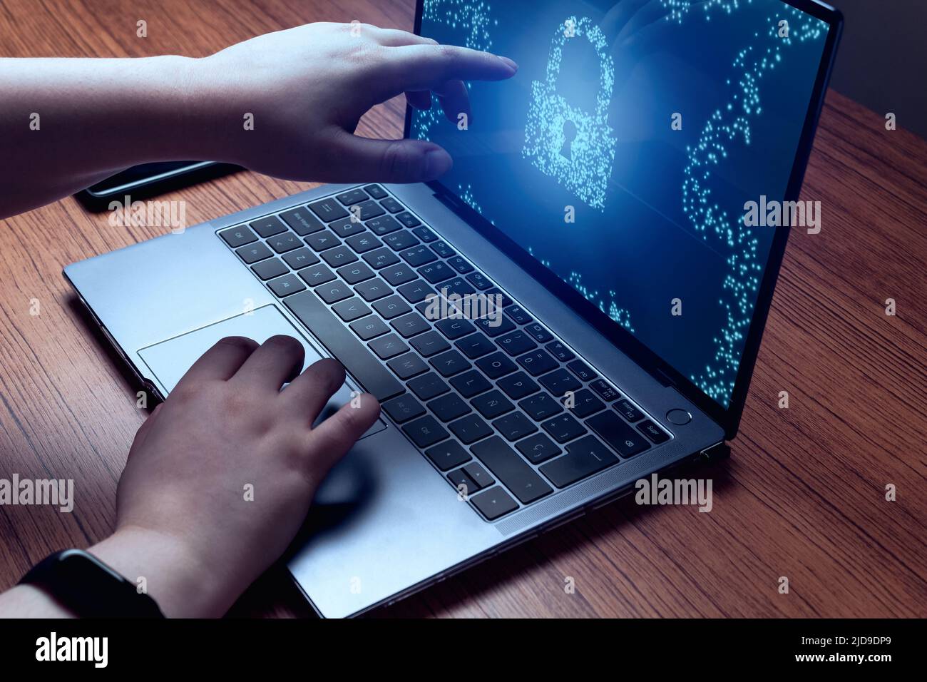 Young woman touching screen with virtual lock for privacy and security. Cybersecurity concept. Protection against dangers. Stock Photo