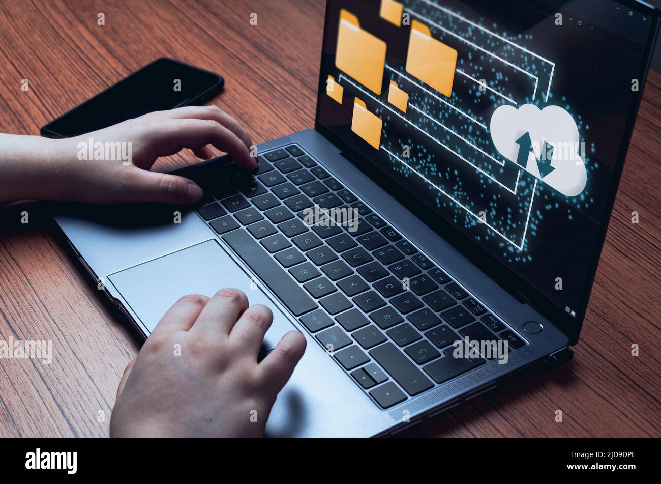Businesswoman using a computer with cloud computing diagram. Data storage. Networking and internet service concept. Stock Photo