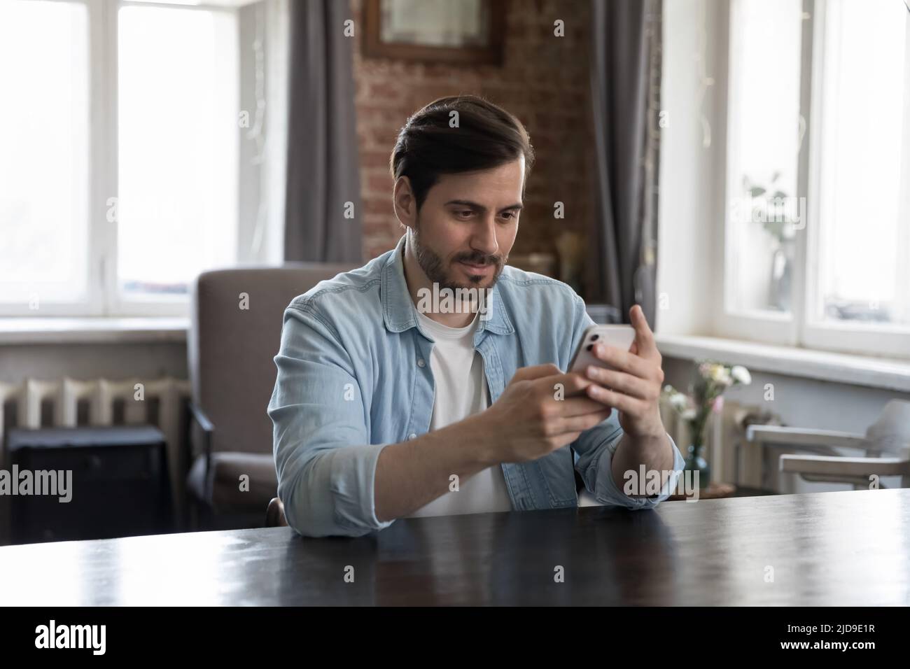 Millennial businessman using mobile business app on smartphone Stock Photo