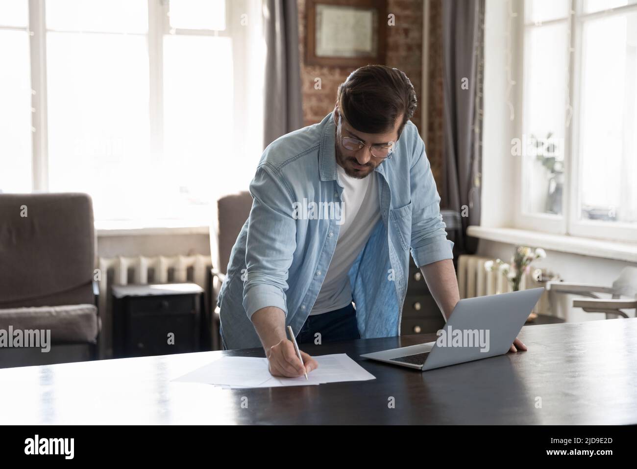 Businessman writes notes on paper, prepare application form, do paperwork Stock Photo