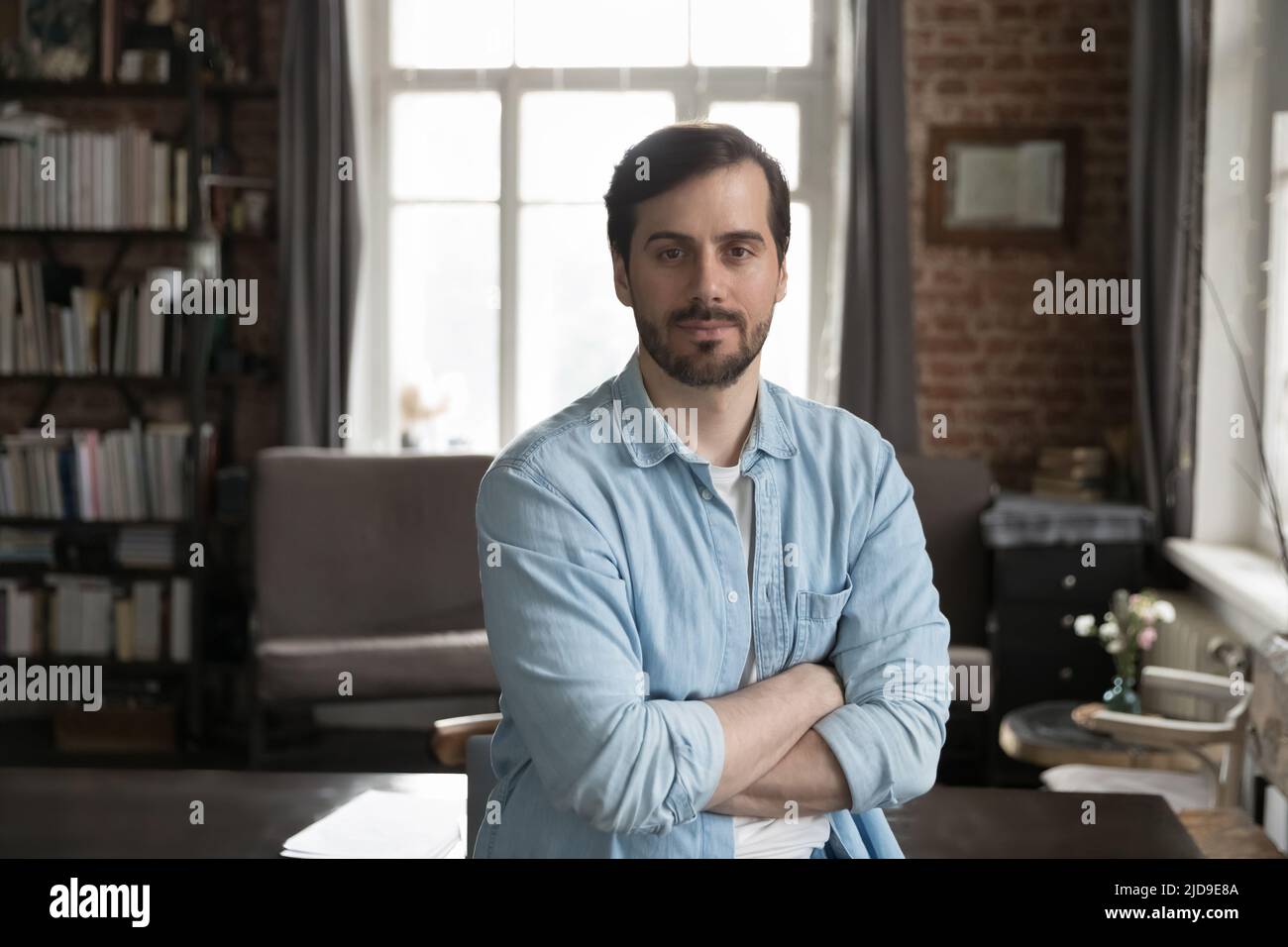 Portrait of handsome business man with arms crossed posing indoor Stock Photo