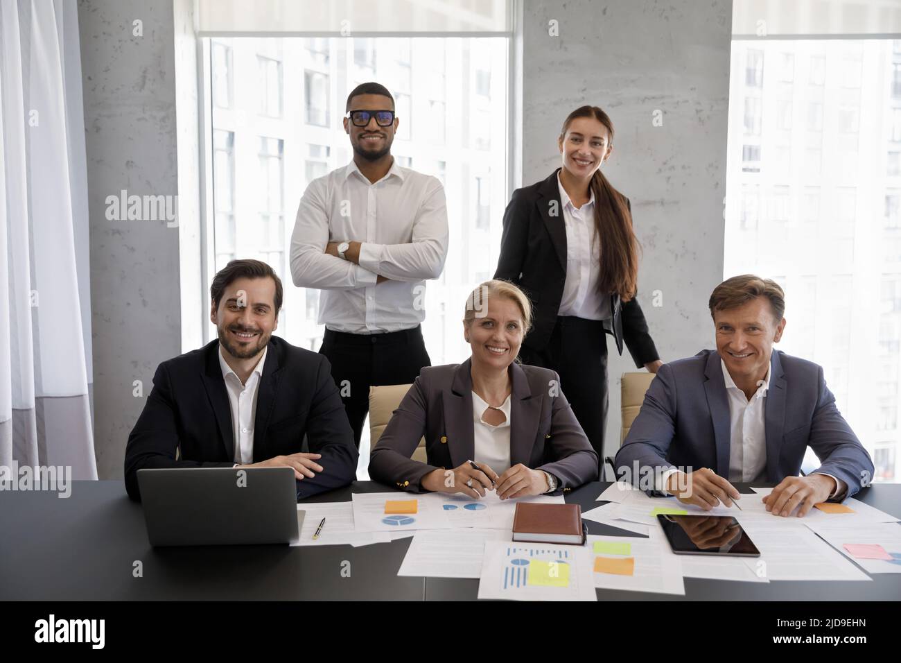 Group of diverse businesspeople posing in office for corporate picture ...