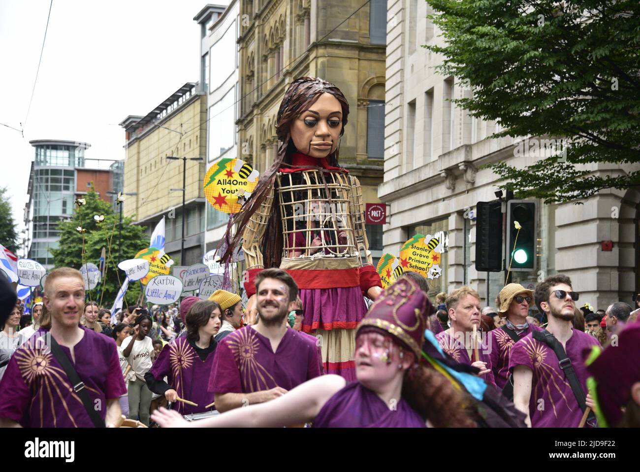 Manchester, UK, 19th June, 2022. Little Amal, Syrian puppet girl and also a 3.5-metre, partly-animatronic, giant puppet. Performers and artists take part in the Manchester Day Parade, Manchester, England, United Kingdom. Organisers say: "Over 1,500 performers and artists from local communities bring Manchester city centre to life in a fantastic display of colour, sound and movement. An audience of more than 60,000 are wowed by the incredible day of amazing structures, vibrant costumes and pulsating music and dance". Credit: Terry Waller/Alamy Live News Stock Photo