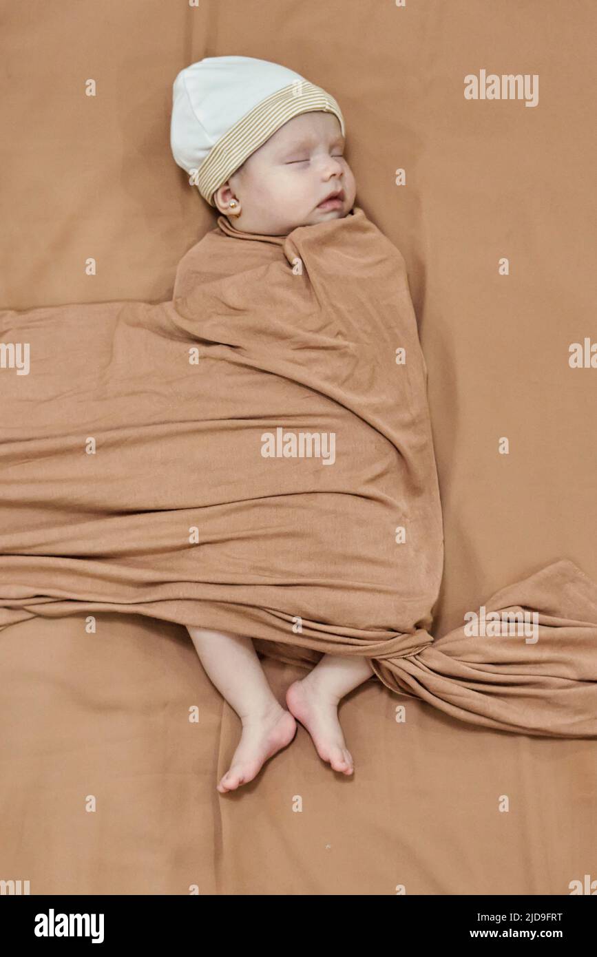 Newborn baby girl, sleeping on a blanket. Stock Photo
