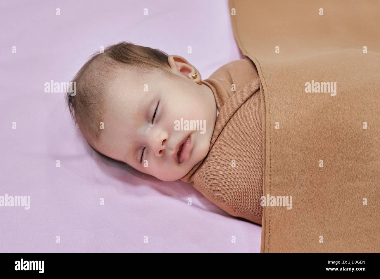 Newborn baby girl, sleeping on a blanket. Stock Photo