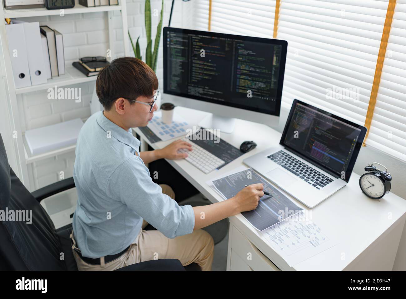 Software development concept, Male programmer pointing on data code to checking website programming. Stock Photo