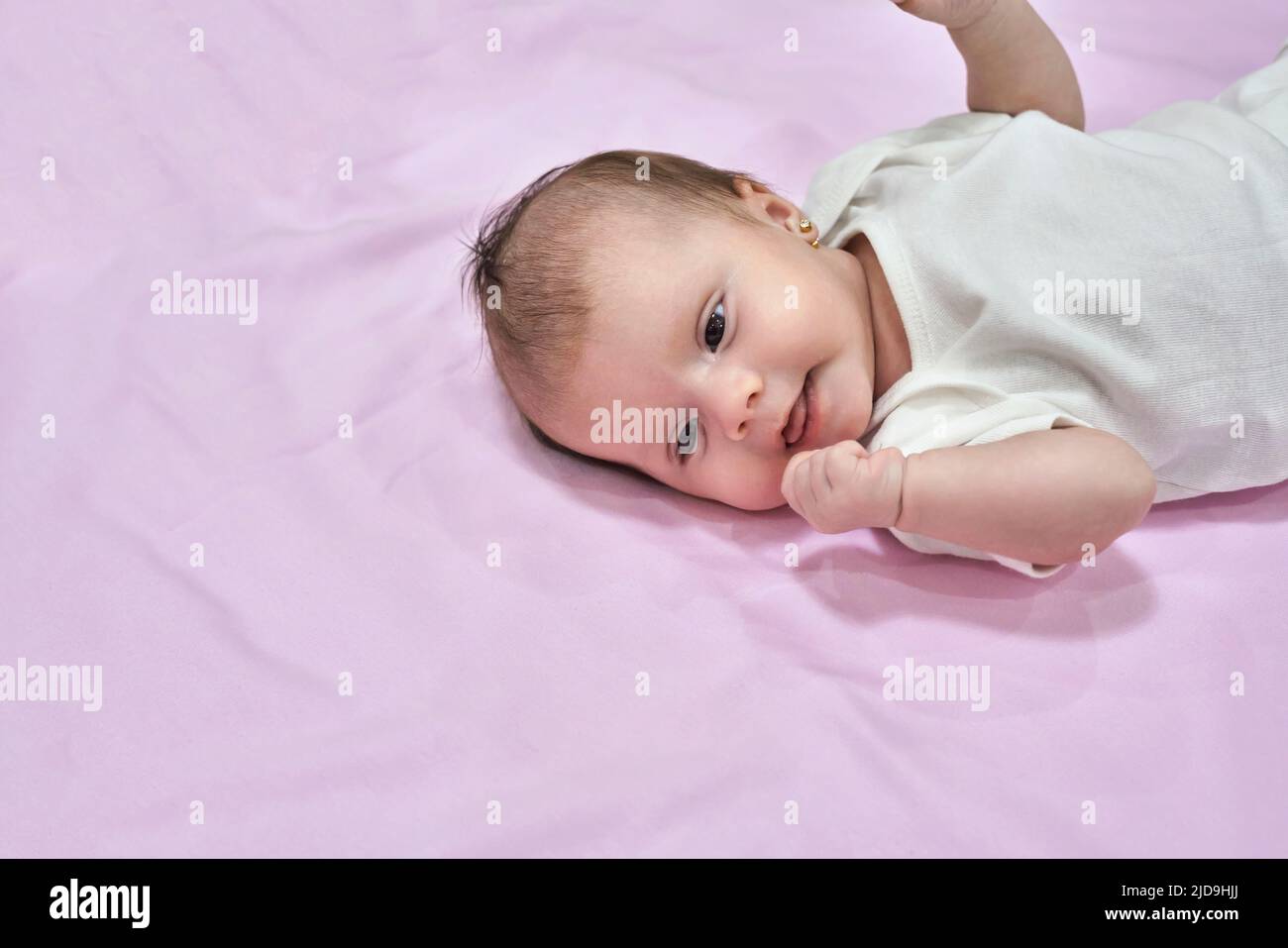 Newborn baby girl sleep on pink blan. Close up Stock Photo