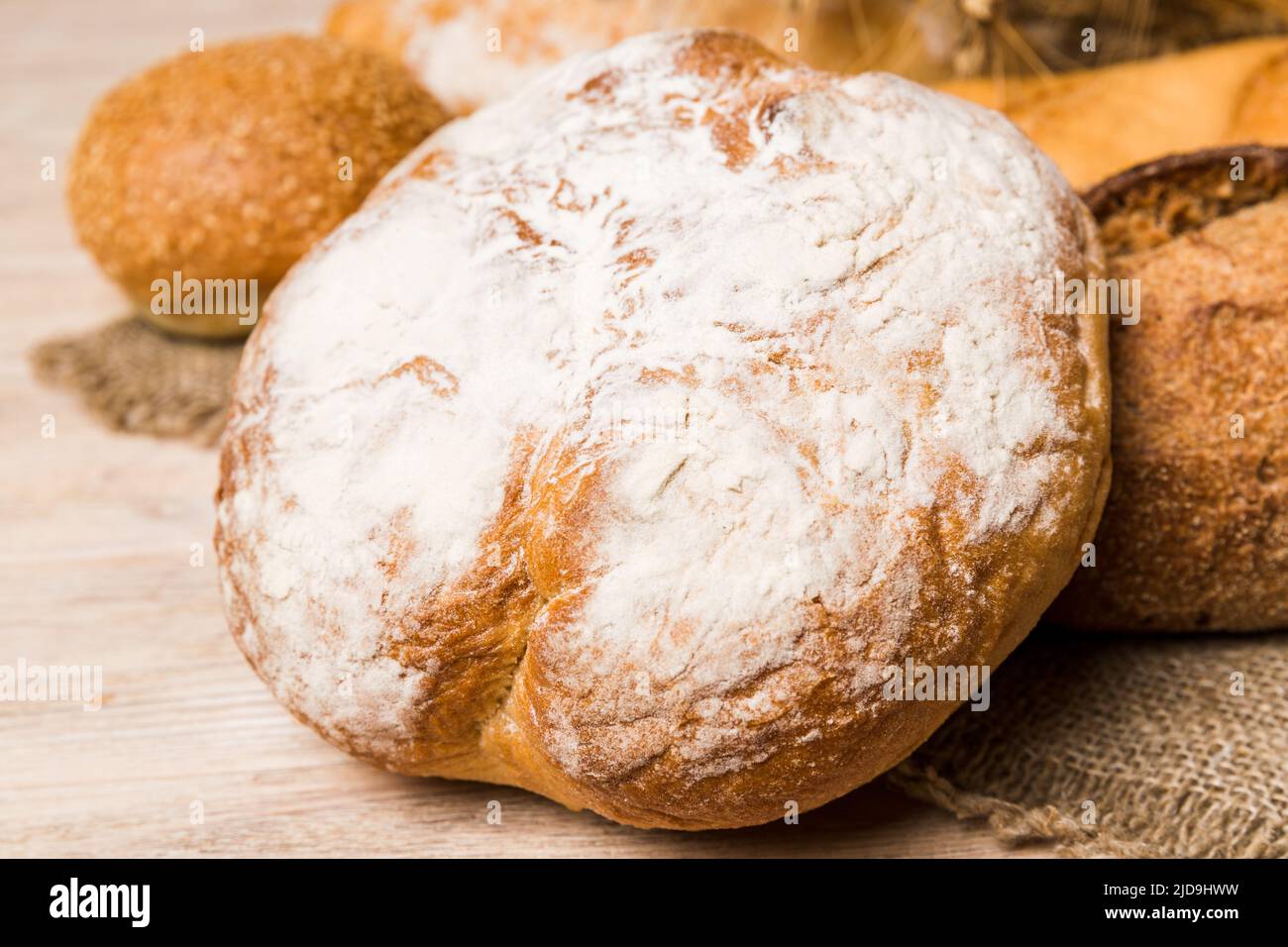 Homemade natural breads. Different kinds of fresh bread as background, perspective view with
