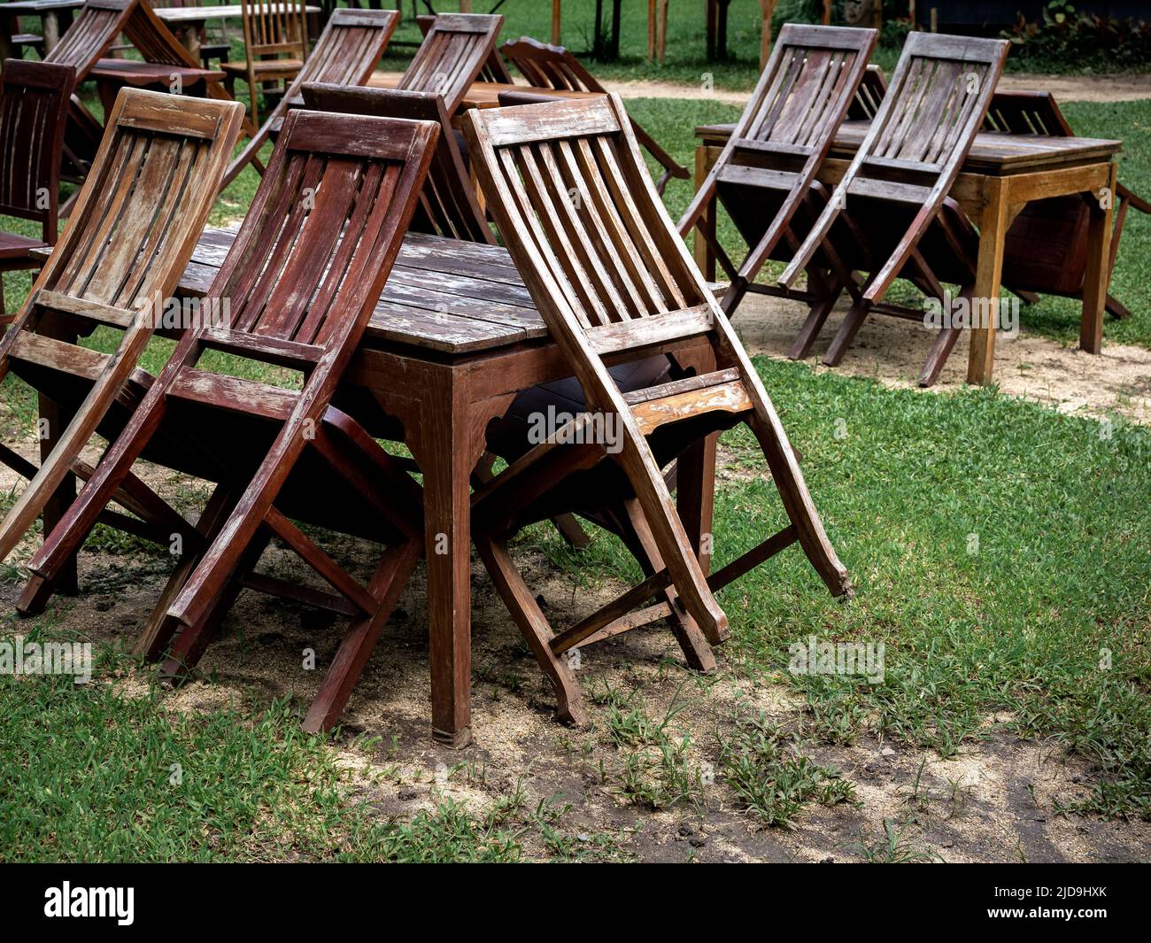 Empty old abandoned wooden dining table set on the green yard garden