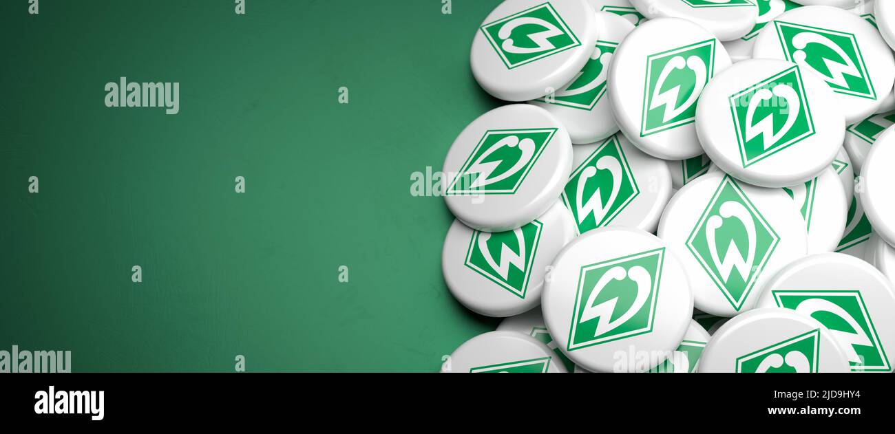 Logos of the German Soccer Club SV Werder Bremen on a heap on a table. Copy space. Web banner format Stock Photo