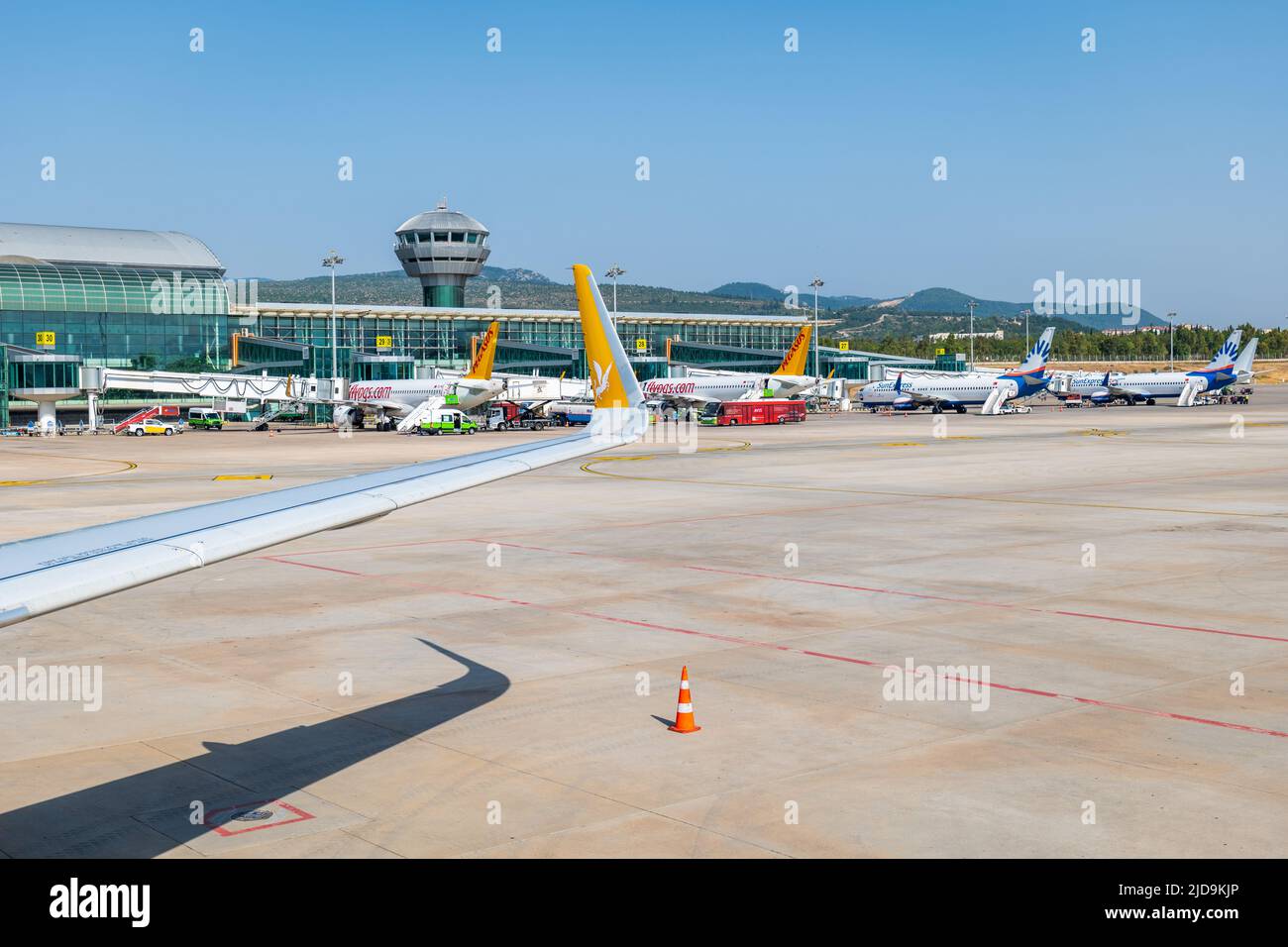 Izmir, Turkey - June 2022: Izmir Adnan Menderes airport departure terminal and runway with aircrafts.  Izmir Airport Stock Photo