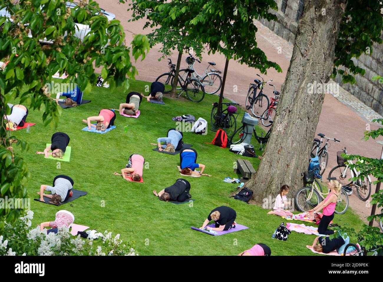 Late afternoon exercise class in the park outside National Museum in Helsinki, Finland June 2022 Stock Photo