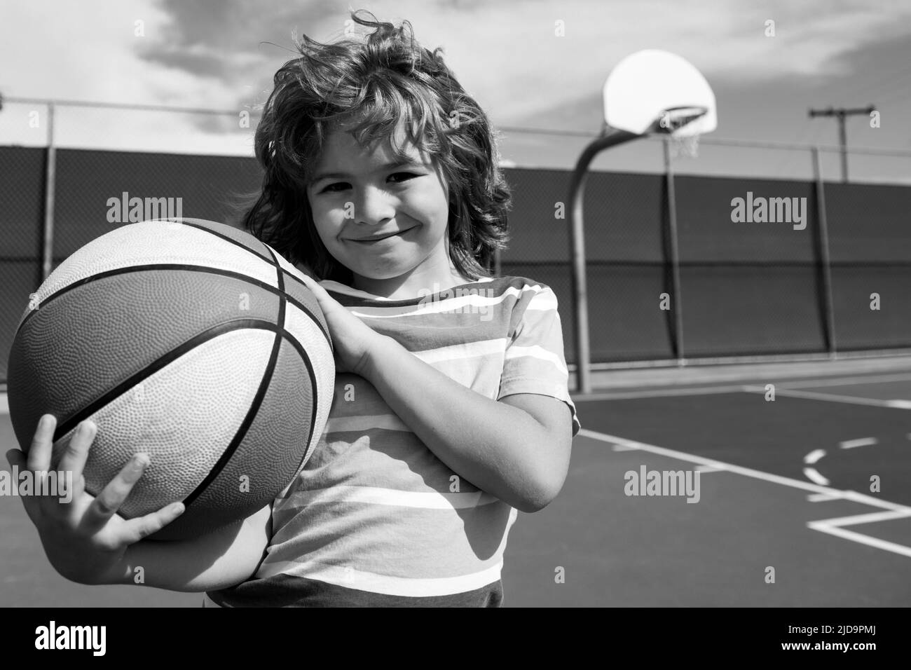 Little child boy playing basketball with basket ball. Active kids