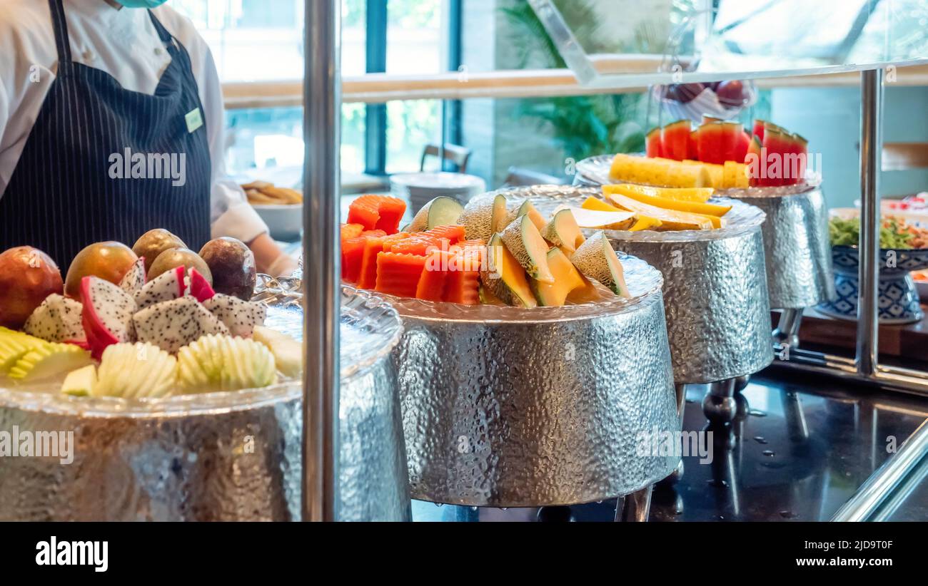 Breakfast buffet in modern hotel. Freshly tropical fruits in luxury