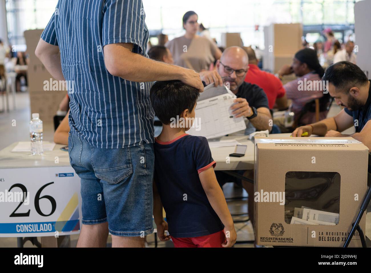 Father and son seen during the elections at the Casa de Campo Pavilion