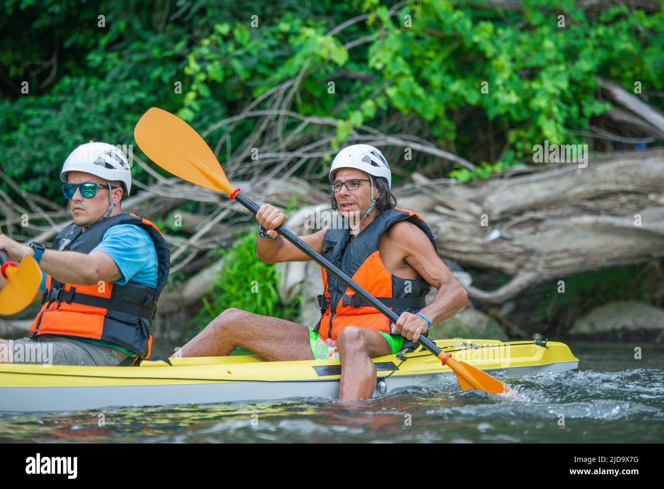 Portrait of two senior and handsome males canoeing together on the same