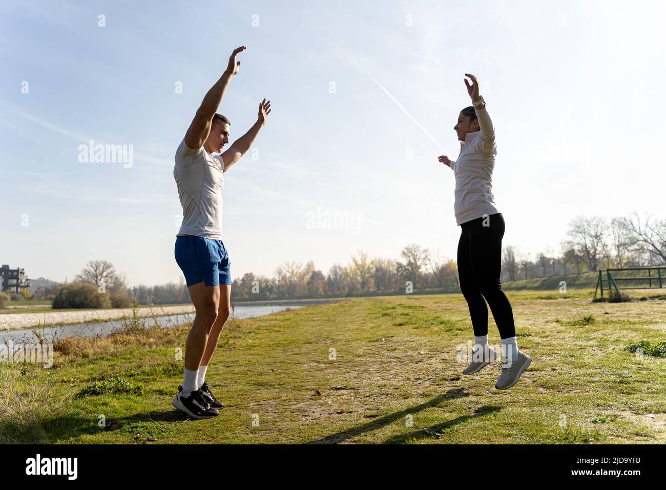 Two amazing and fit friends are doing a jumping jet exercise and