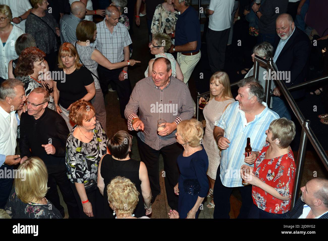 Reunion of Mods from the 1960s.dancing to Soul Music disco in 2015 Britain, Uk. Centre of pic two old friends suddenly recognise each other. Stock Photo