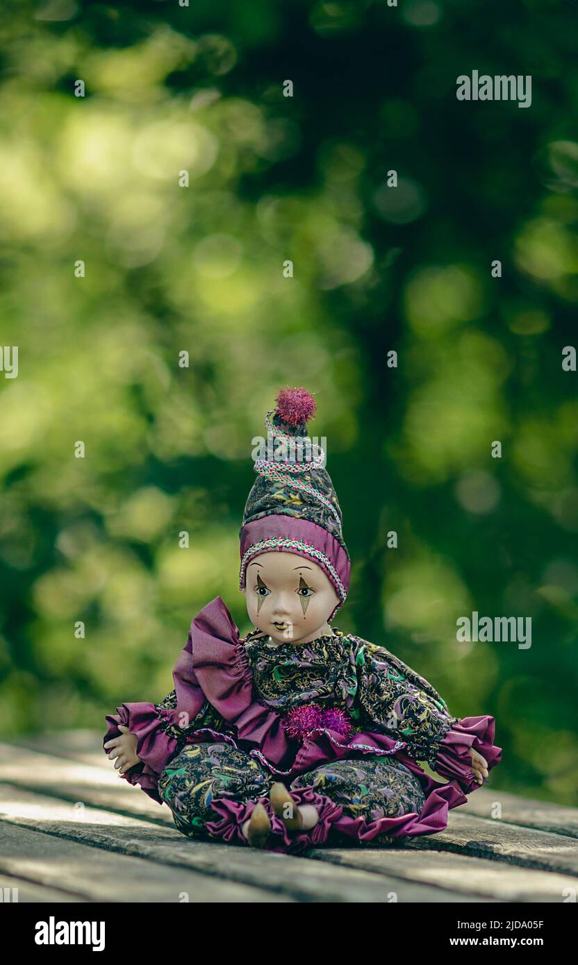 Amazing realistic vintage porcelain doll, toy, harlequin, selective focus Stock Photo